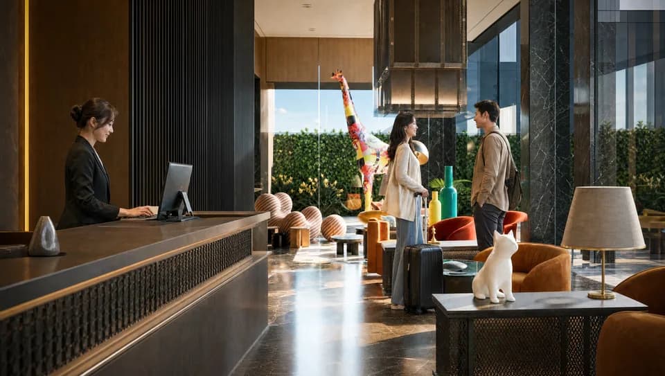 Panoramic view of an office lobby with stone-clad walls, a reception desk and double-height glazing.