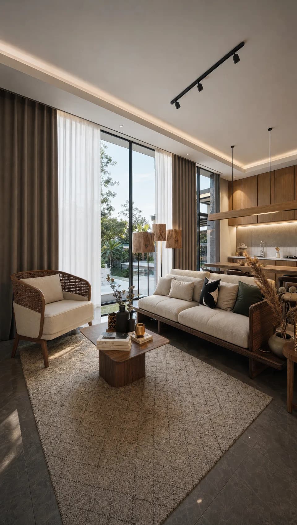 Interior of a villa living room with full-height glazing, stone flooring and rattan seating, morning light.