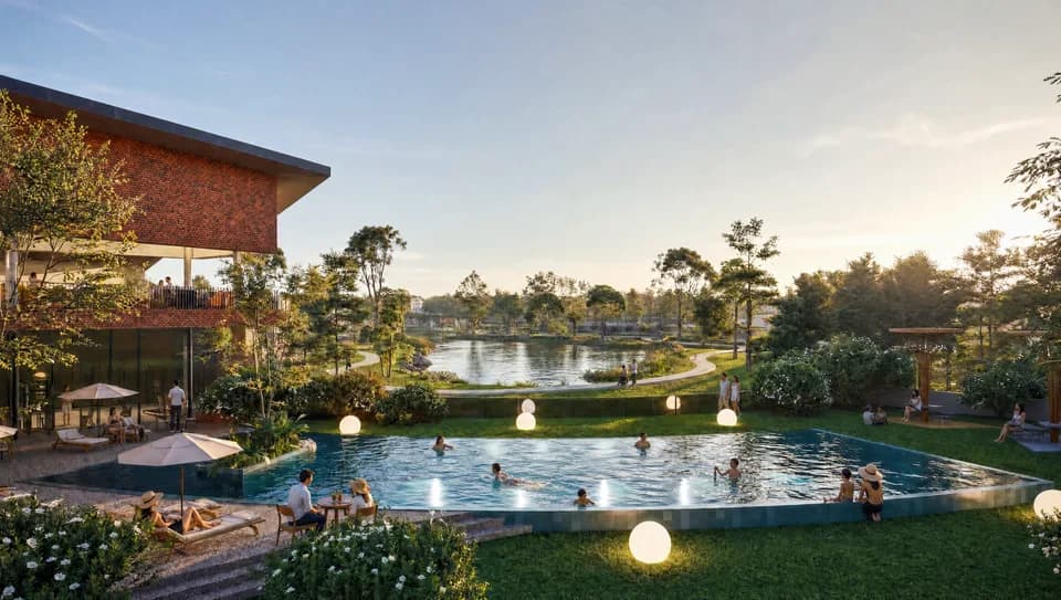 Eye-level view of a clubhouse entrance with deep concrete canopy, reflecting pool and planting, dusk.